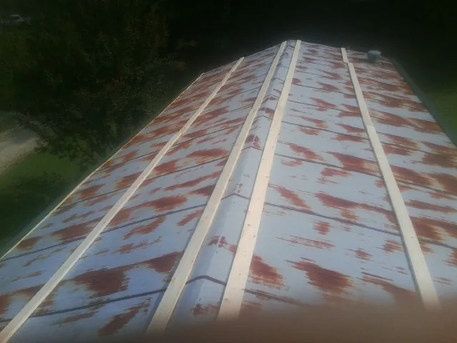 Rusted metal roof panels with new wood purlins before replacement — Storm Damage Roof Repair in Accident by Roofing Brothers